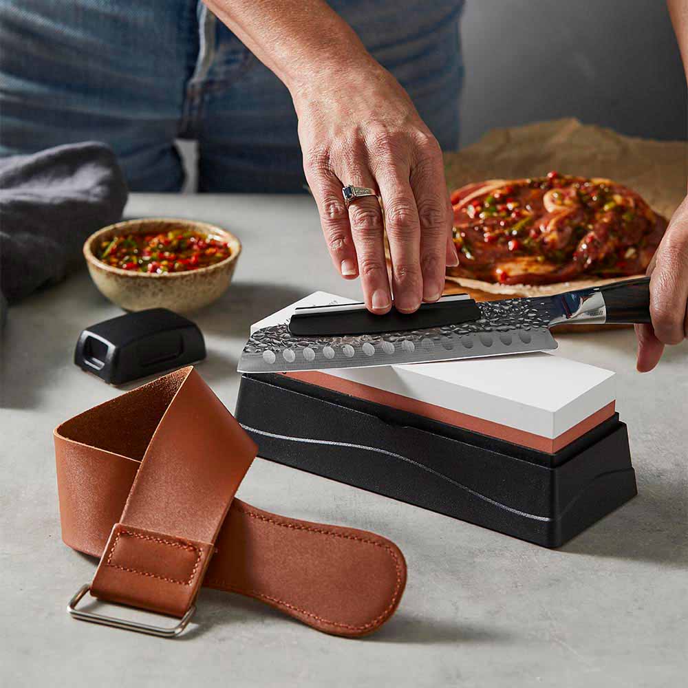 Woman sharpening knife with a whetstone - MyHouse