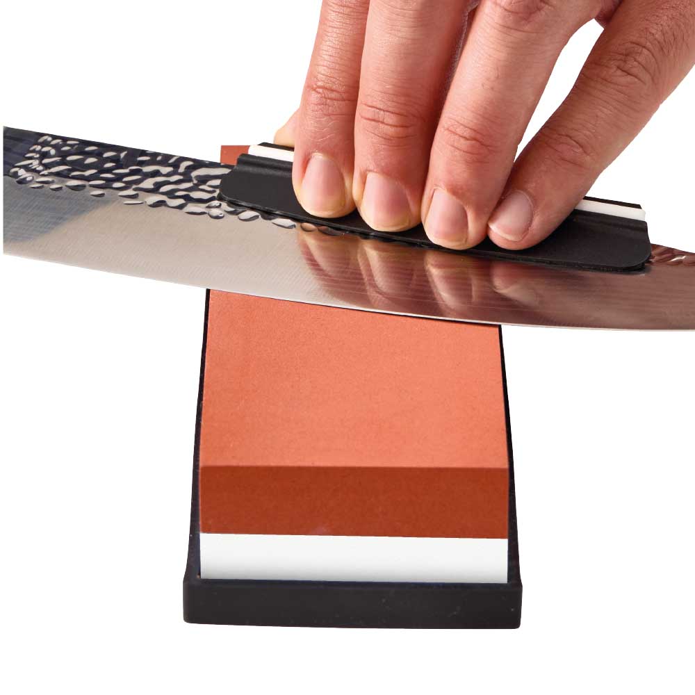 Man sharpening knife with whetstone - MyHouse