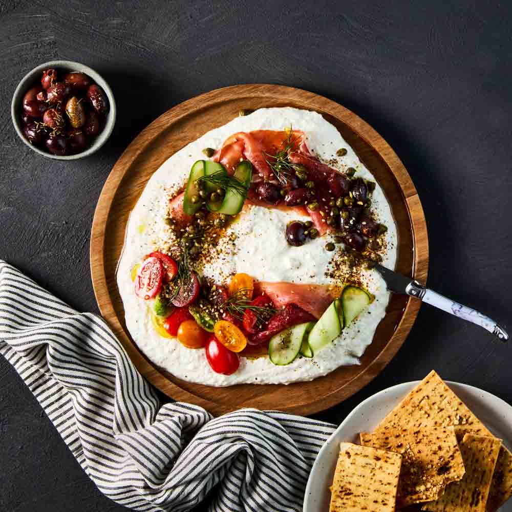 dip with corn chips on a wooden platter - MyHouse