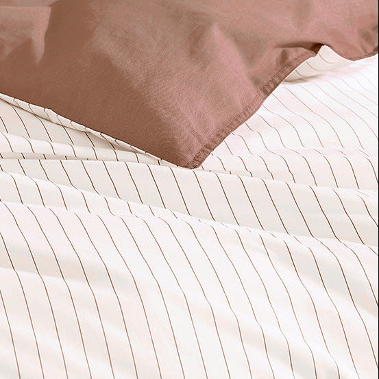 Close-up of striped bedding with a brown comforter