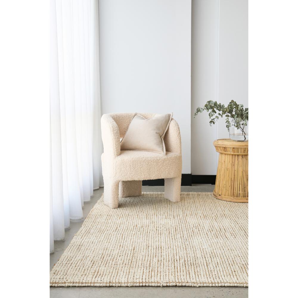 Cream white jute rug with boucle chair and wicker table - MyHouse