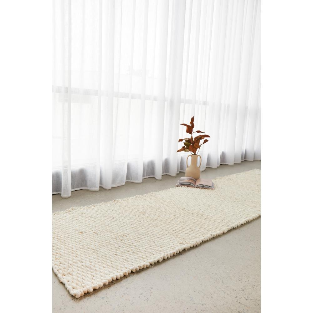 beige white Jute Hampton Rug by a window - MyHouse