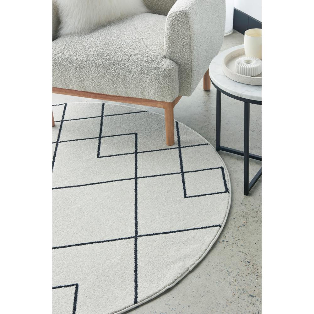 grey abstract round rug with armchair and side table - MyHouse