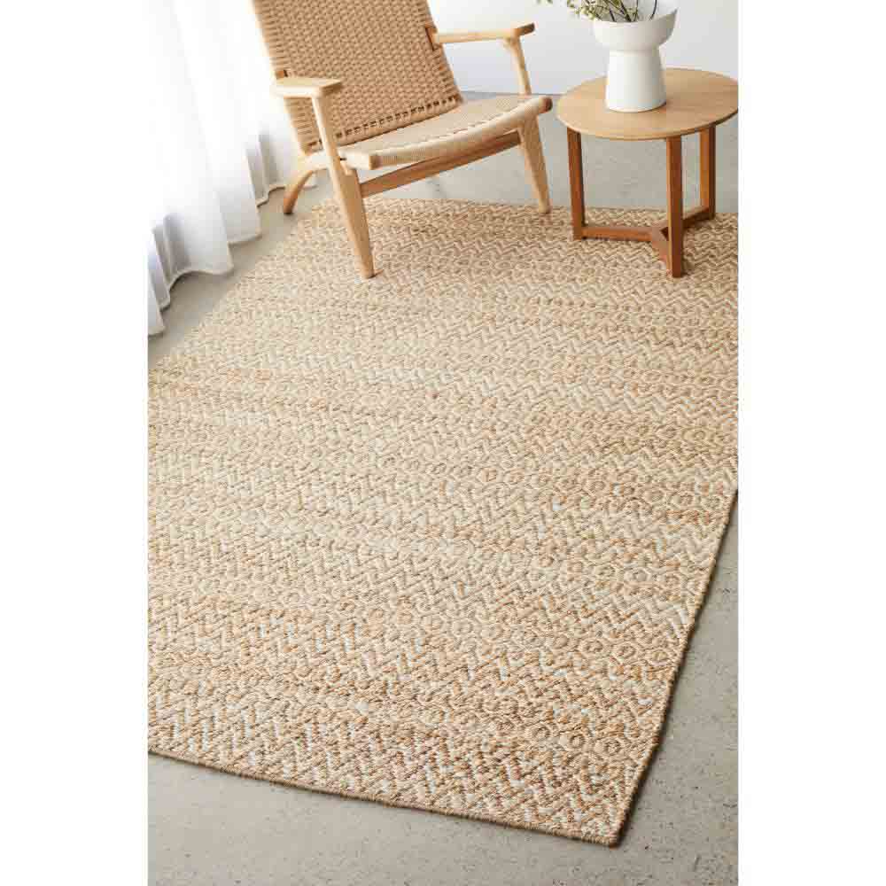 warm beige textured jute rug with an armchair and table - MyHouse