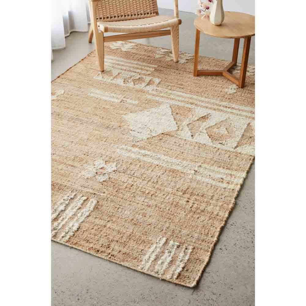 warm beige patterned jute boho rug with armchair and table - MyHouse