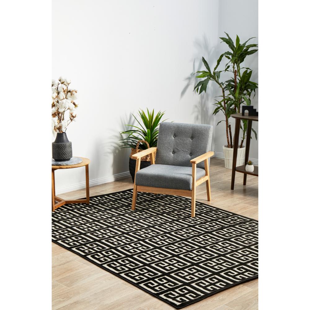 black and beige art deco tile rug with armchair and table - MyHouse