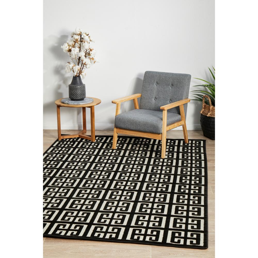 black and beige art deco tile rug with armchair and table - MyHouse