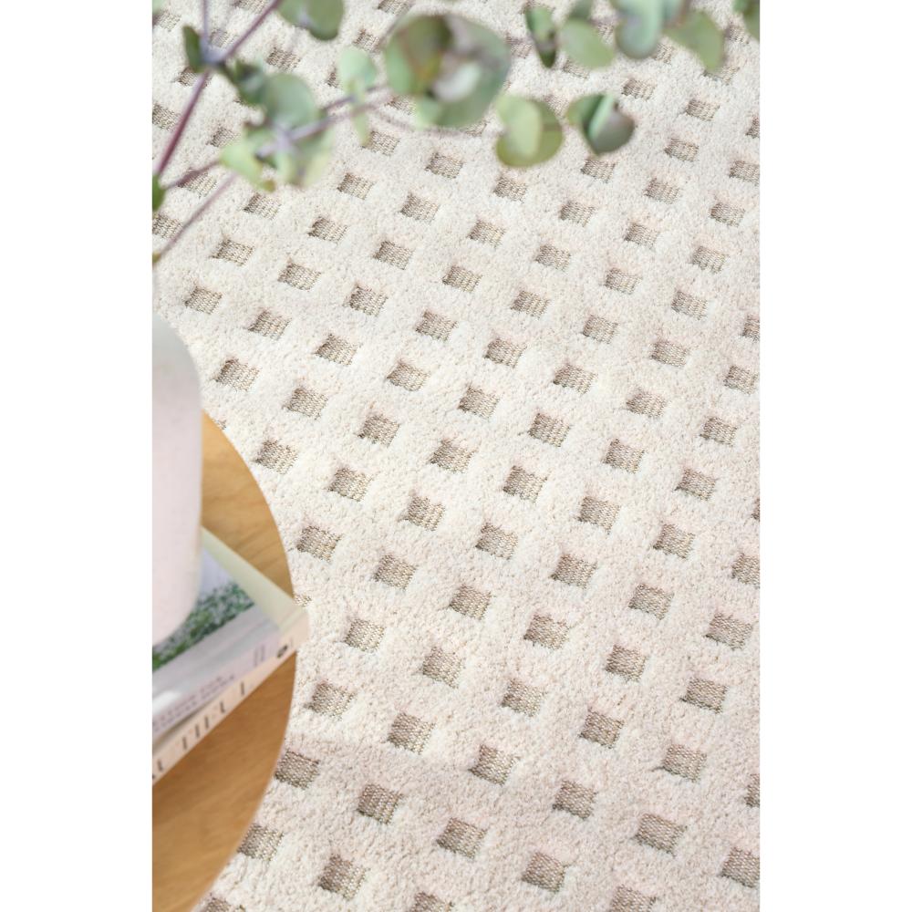 Natural beige small grid rug with table, books, and vase - MyHouse