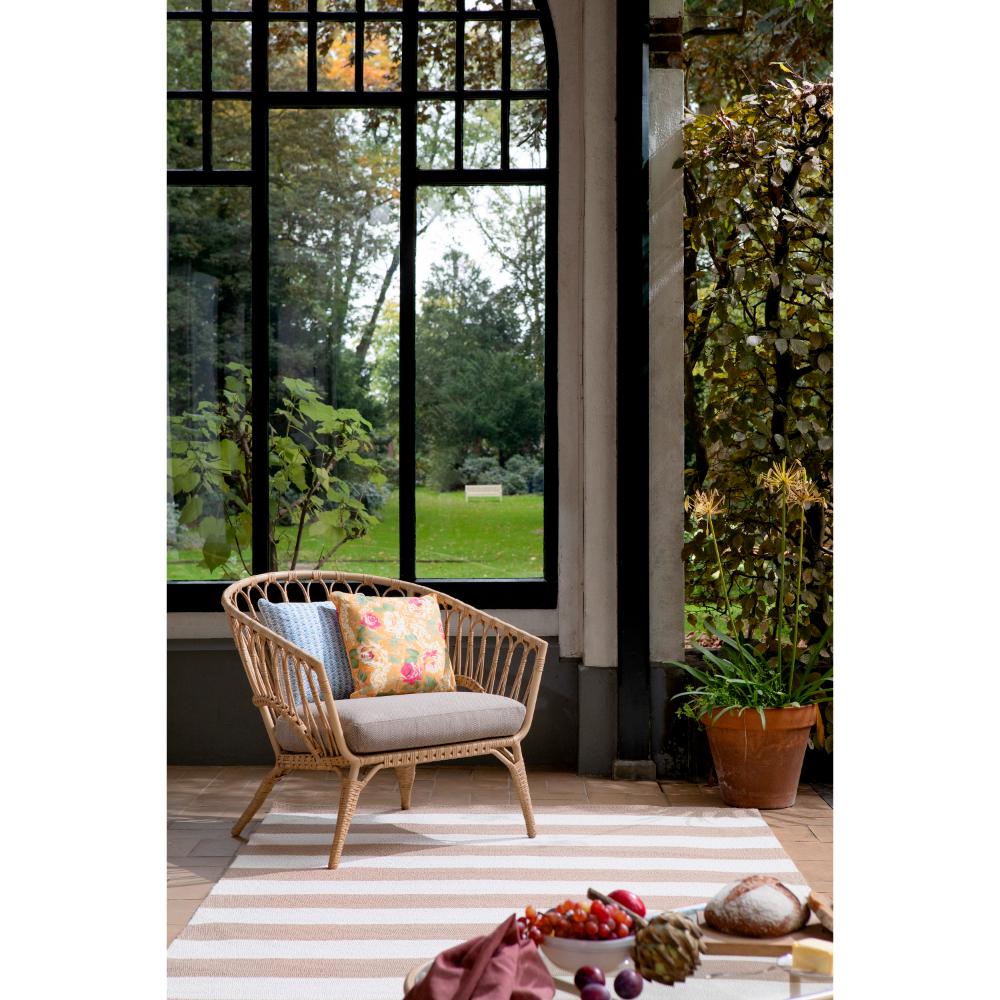 beige and white striped rug in sunroom with armchair - MyHouse