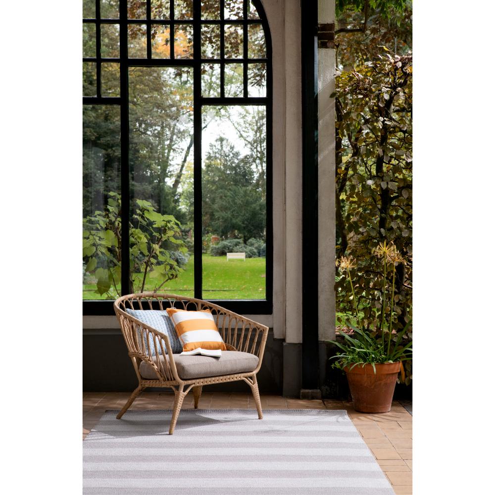 grey and white striped rug in sunroom with armchair - MyHouse
