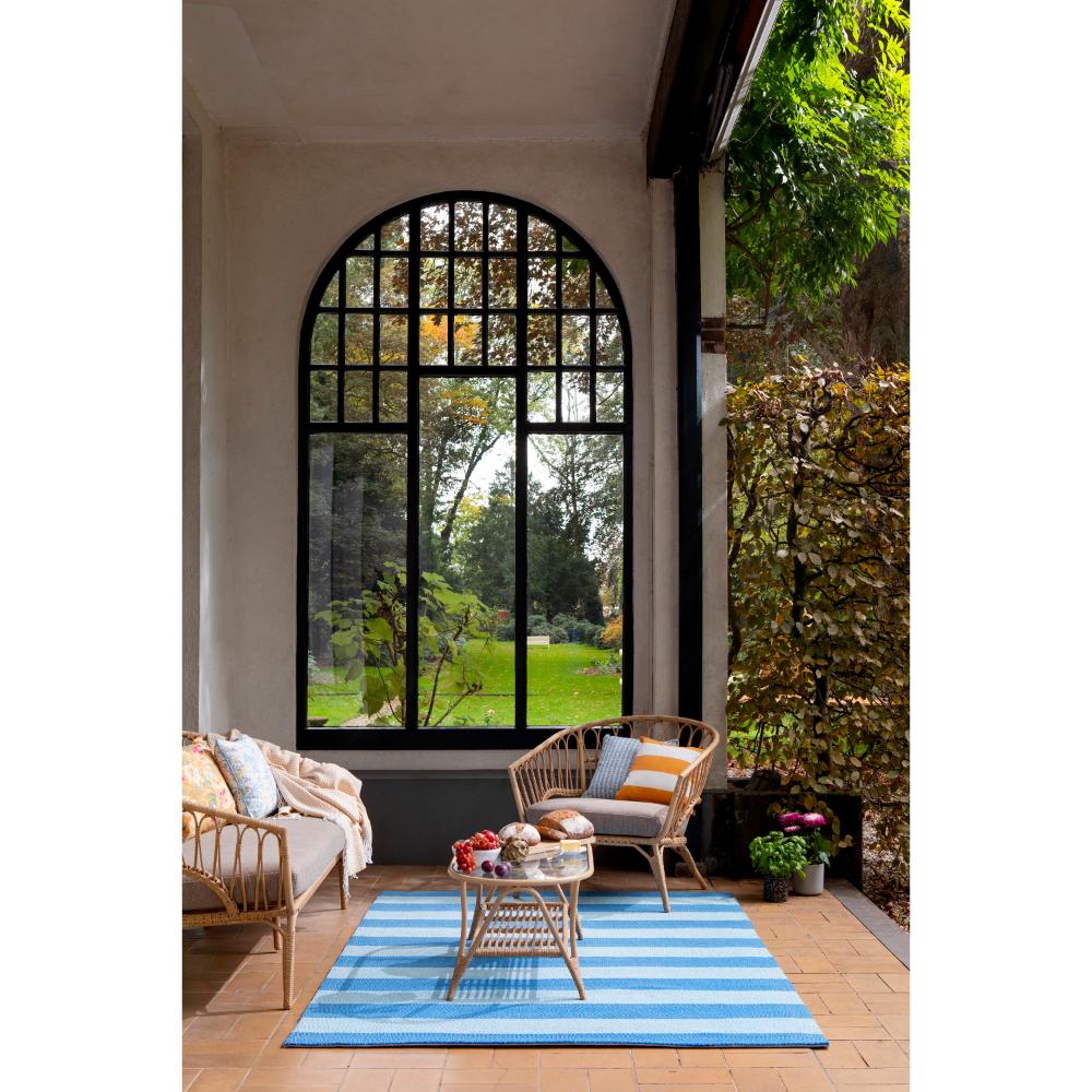 blue striped rug in sunroom with armchair - MyHouse