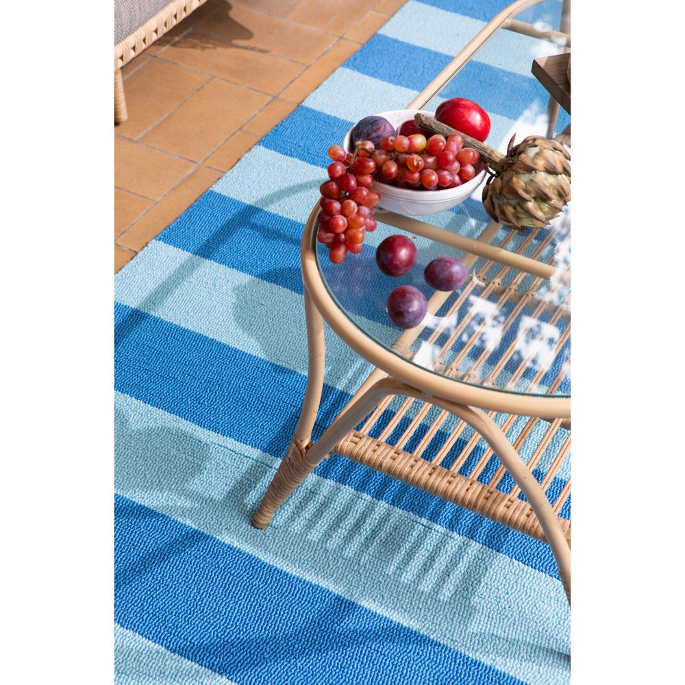 blue striped rug under coffee table with fruit - MyHouse