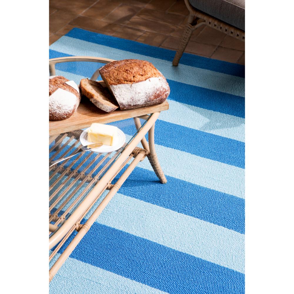 blue striped rug under coffee table with bread - MyHouse