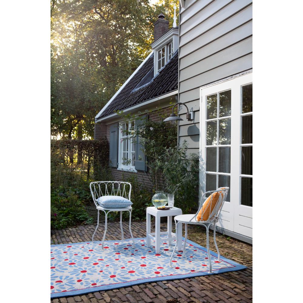 Blue daisies outdoor rug in backyard with setting - MyHouse