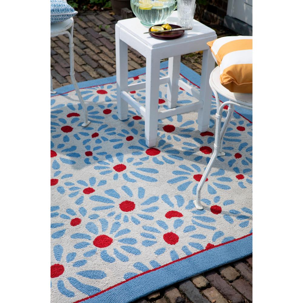 Blue daisies outdoor rug in backyard with setting - MyHouse