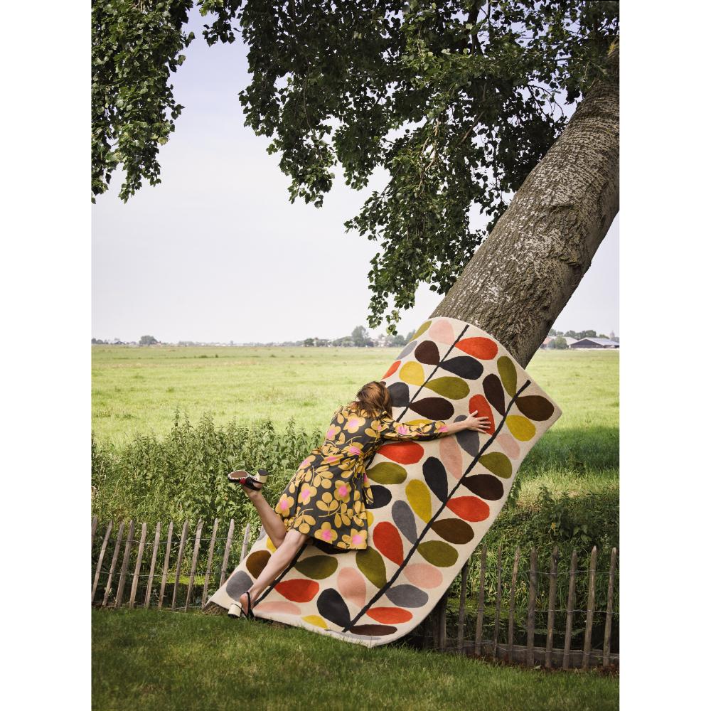 woman hugging flower rug on a tree - MyHouse