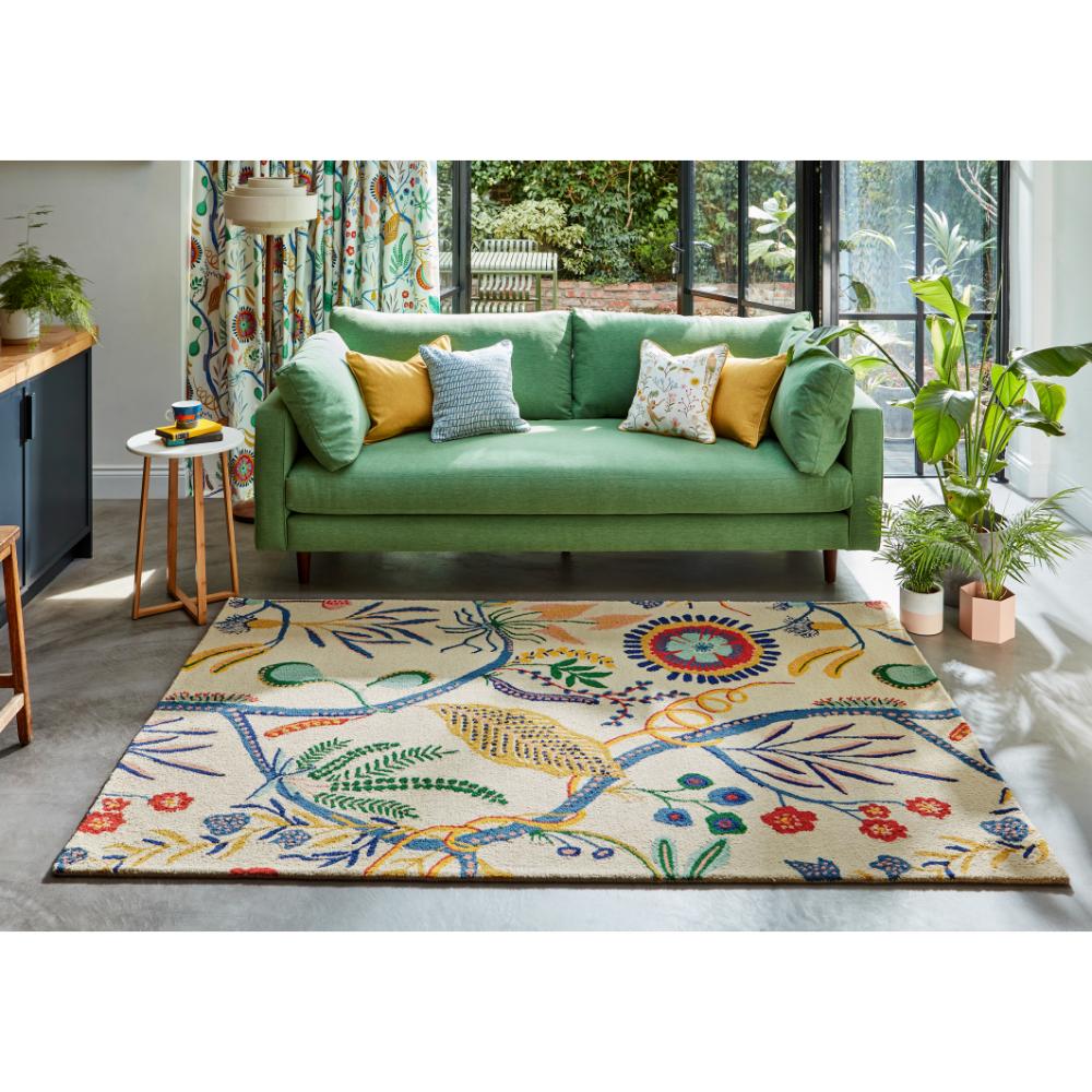 multicolour floral rug with green couch in loungeroom - MyHouse