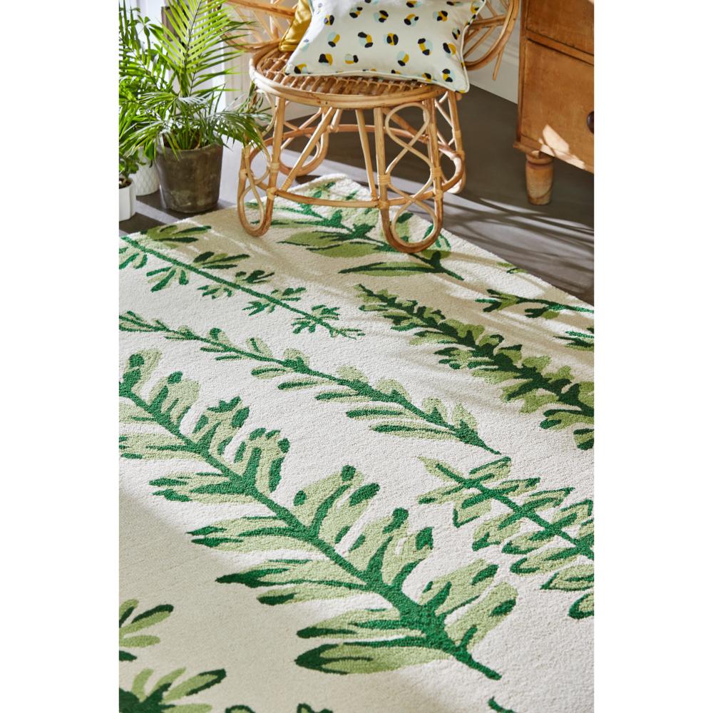 Green fern wool rug with wicker chair - MyHouse