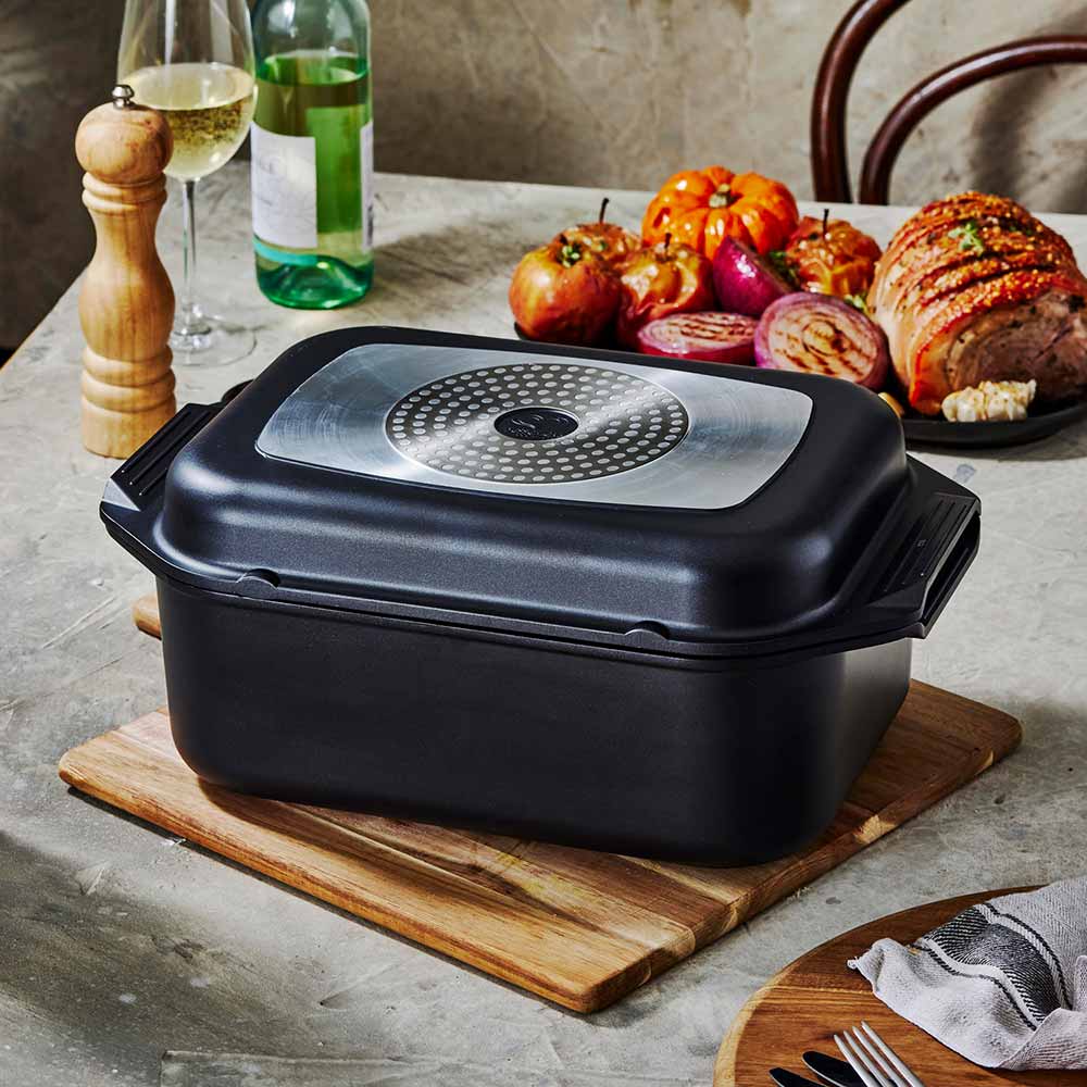 Bessemer Non Stick Roaster & Grill 34cm Black at MyHouse on a wooden board with roast pork and vegetables