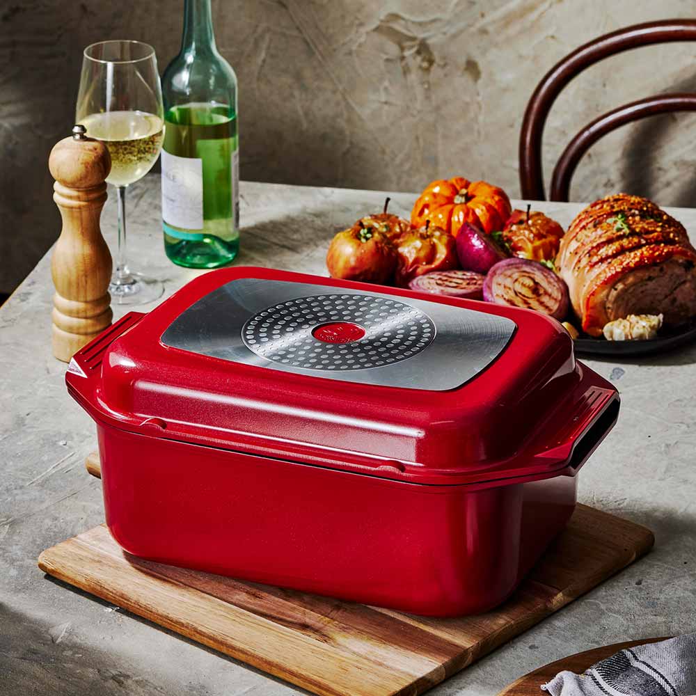 Bessemer Non Stick Roaster & Grill 34cm Red at MyHouse on a wooden board with roast pork and vegetables