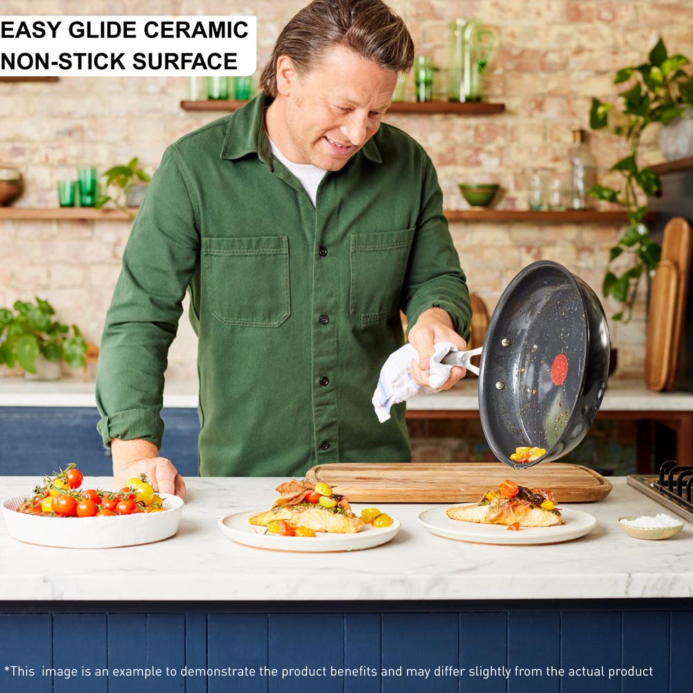 Jamie Oliver sliding food from frypan onto salmon - MyHouse
