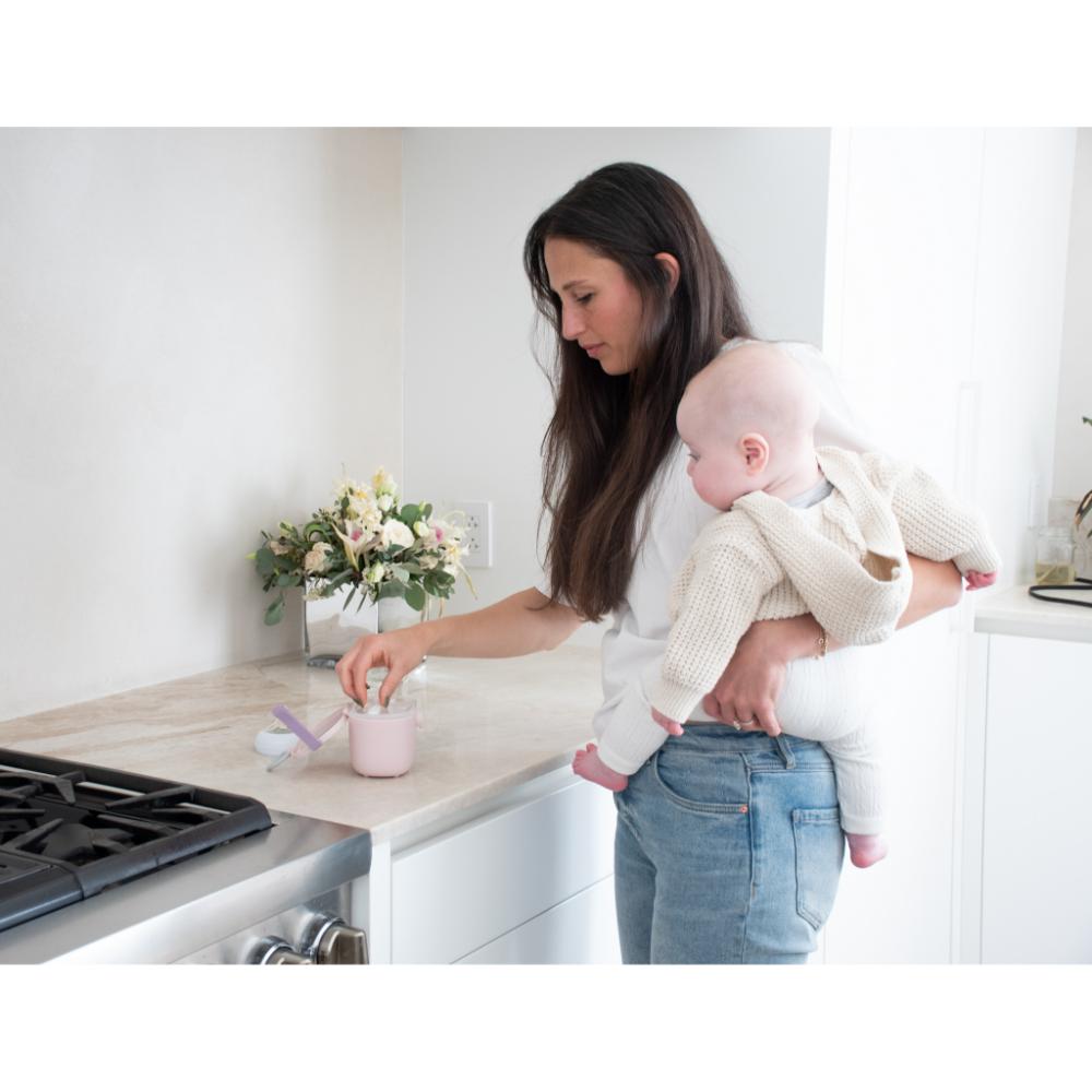 woman with baby preparing baby formula - MyHouse