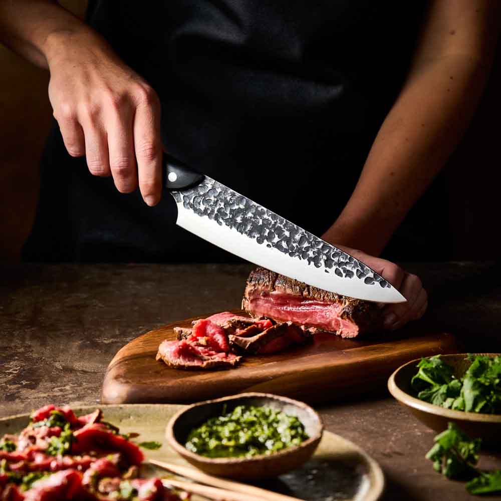 Man slicing wagyu beef with Baccarat KUROI KIBA Chefs Knife 20cm at MyHouse