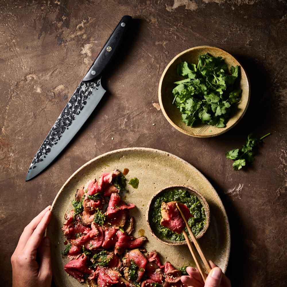 Man dipping sliced wagyu beef - Baccarat KUROI KIBA Chefs Knife 20cm at MyHouse