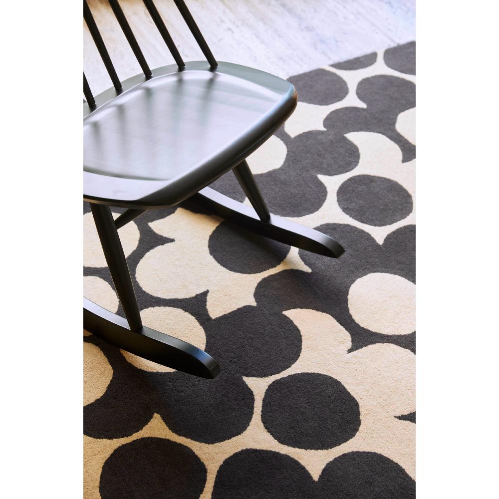 Grey and white flower rug with wooden rocking chair - MyHouse