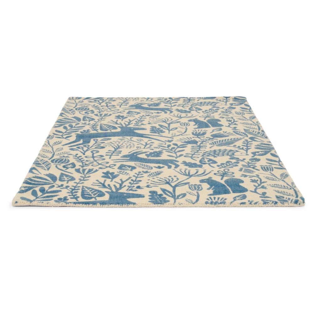 blue printed woodland creatures wool rug angled image - MyHouse