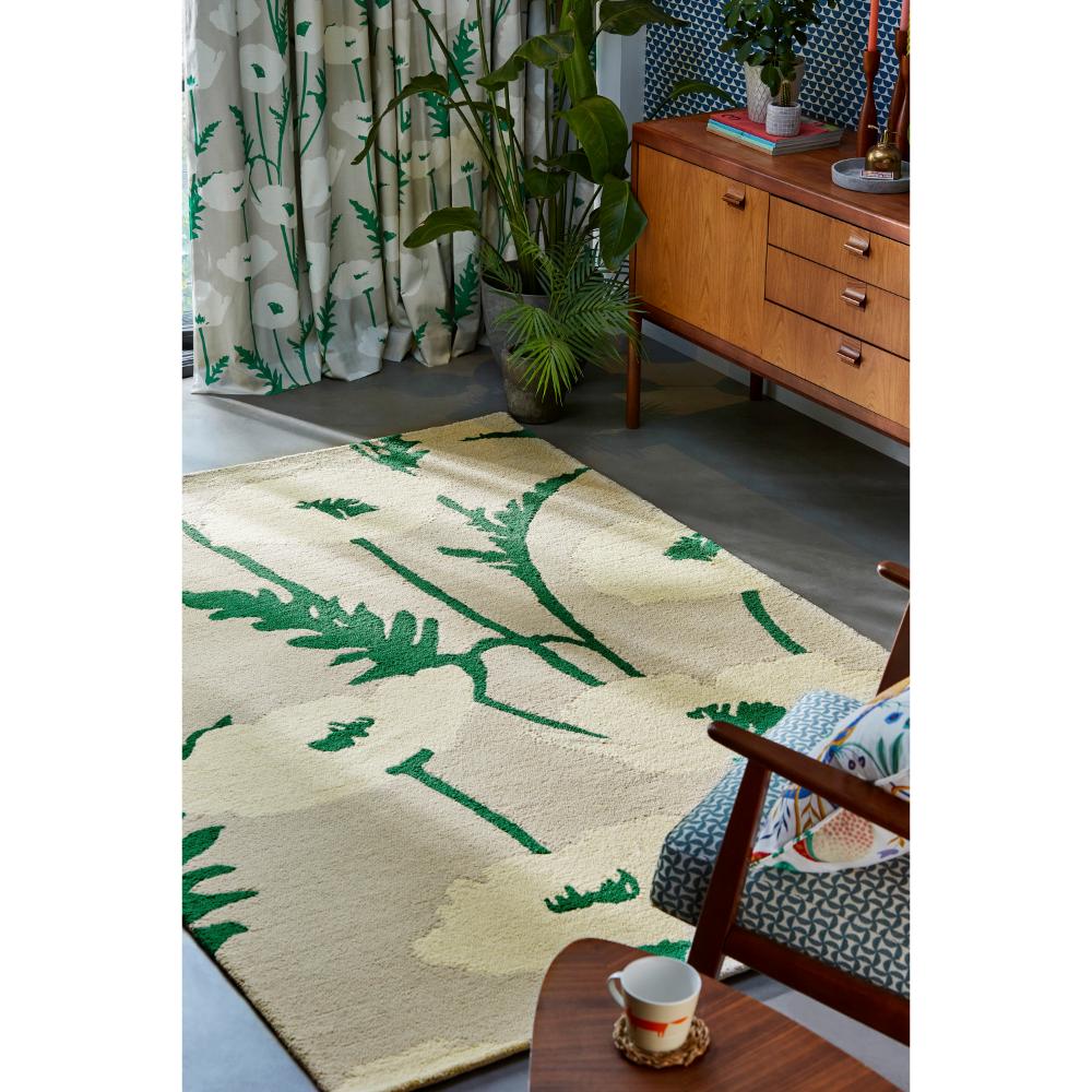 beige wool rug with cream poppies next to armchair - MyHouse