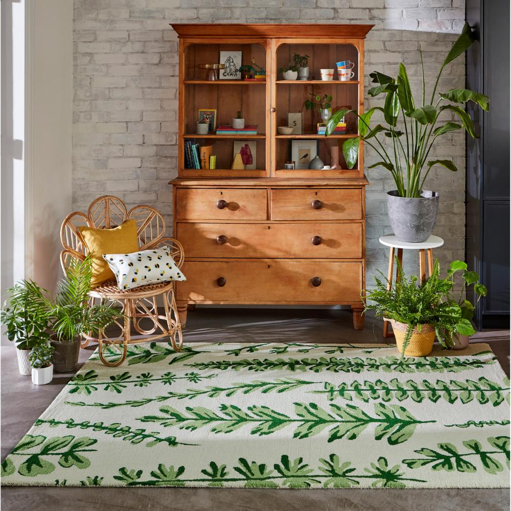 Green fern wool rug with wicker chair in sitting room - MyHouse